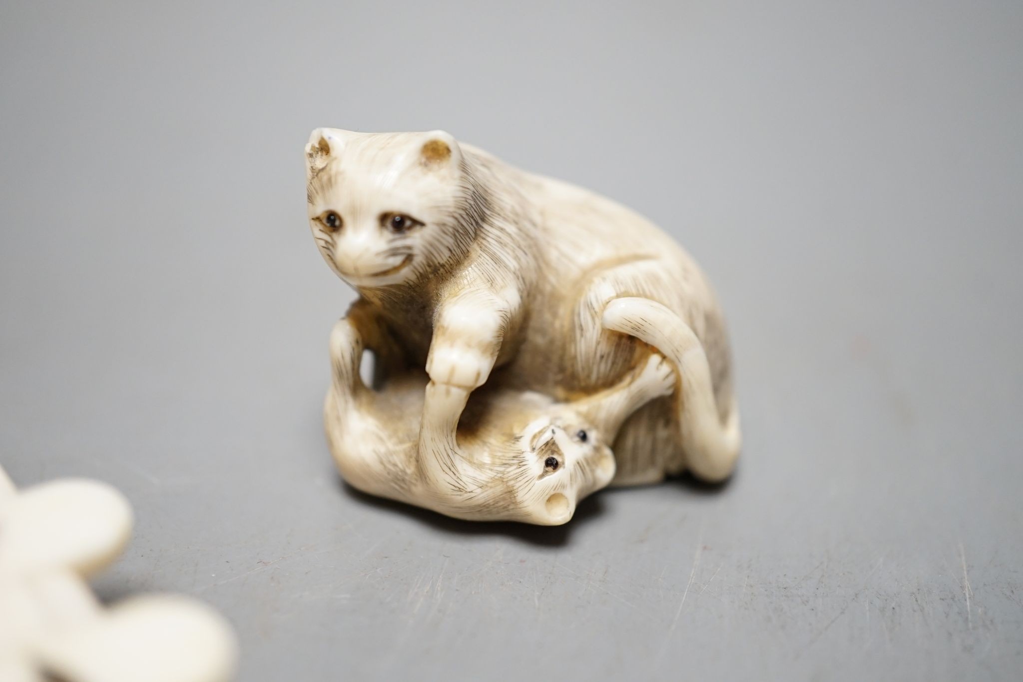 A 19th century ivory netsuke cat group and a Meij period ivory shibayama bezique marker, 9cm.
